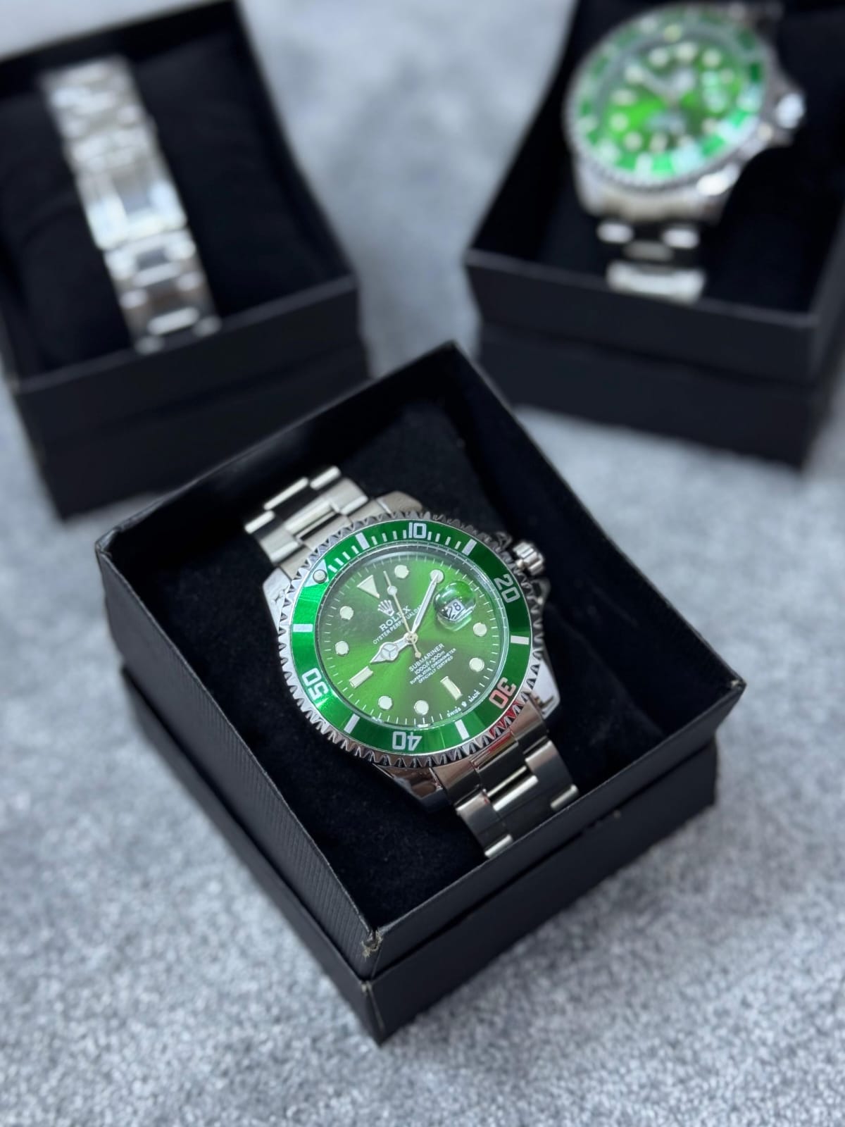 Reloj Rolex plateado y verde