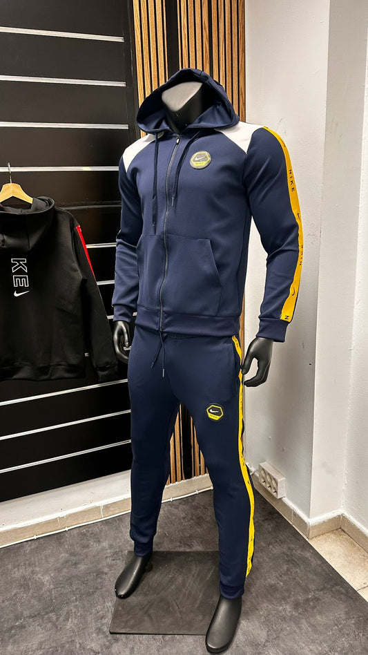 Chandal Nike azul marino logo blanco y amarillo detalles amarillo laterales
