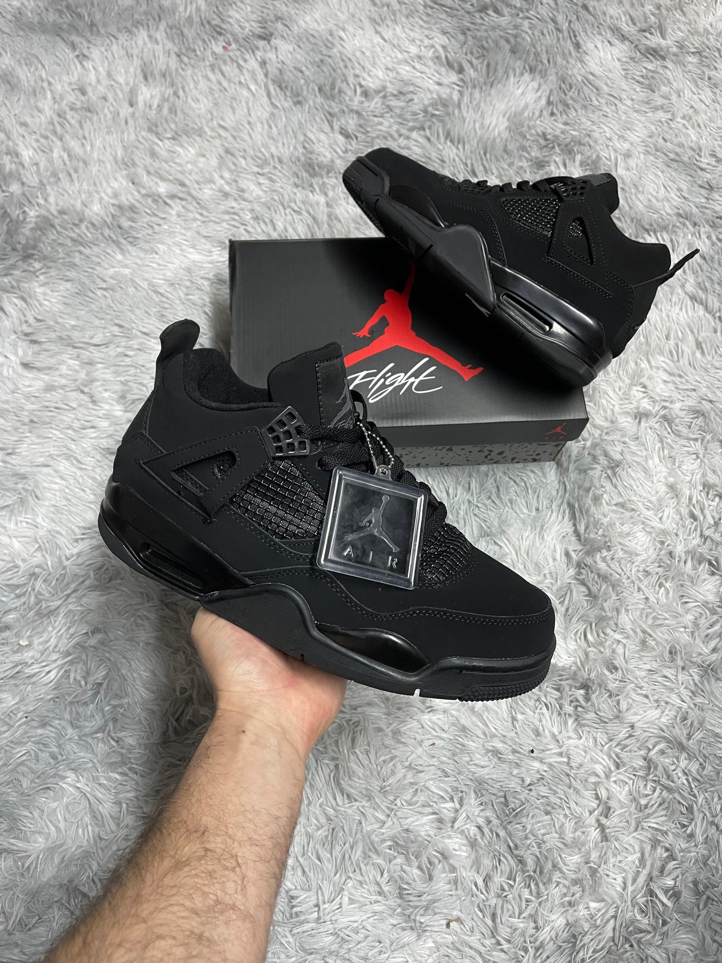 JORDAN 4 NEGRAS logo gris