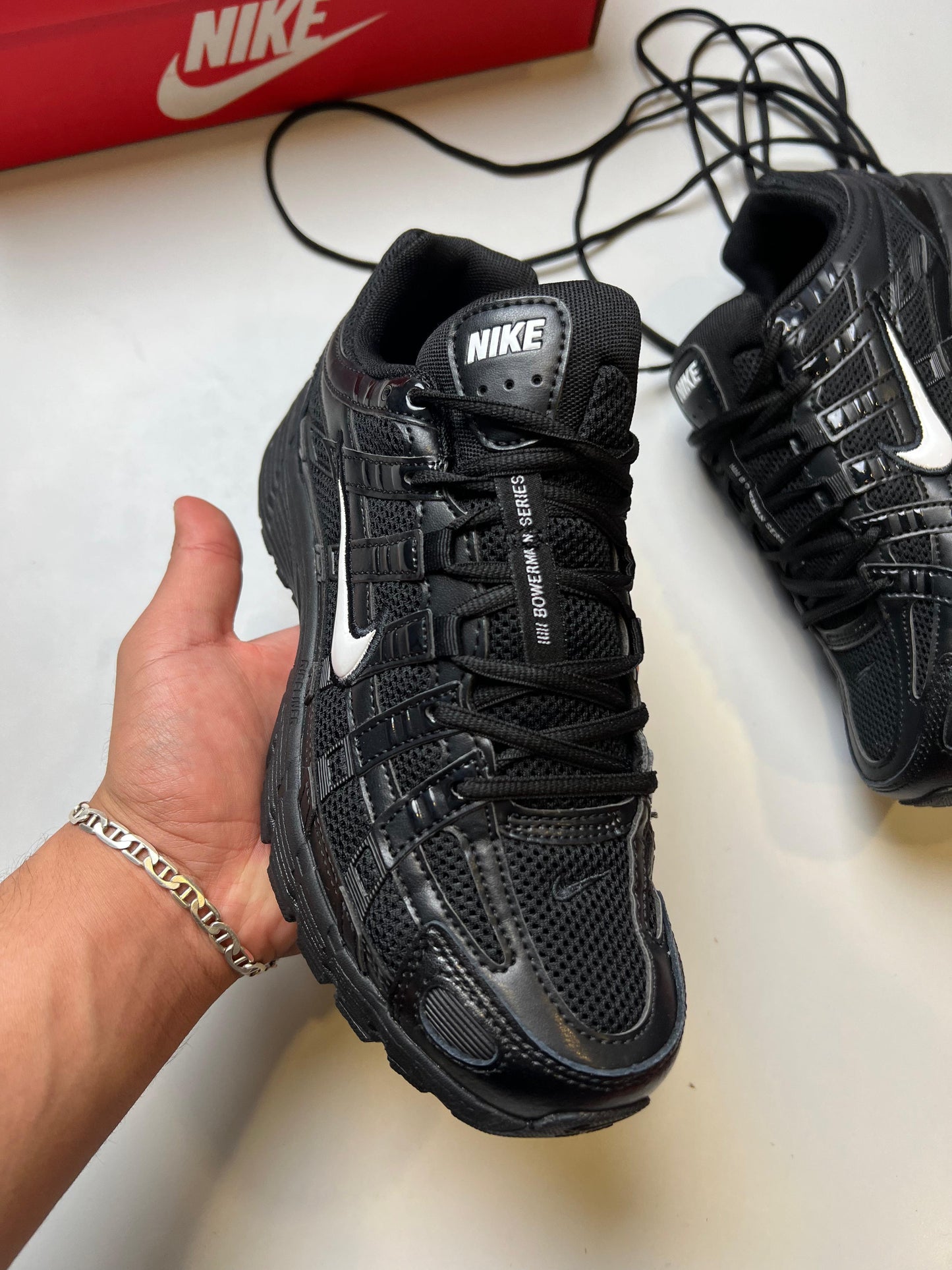 Nike P-6000 negras logo banco