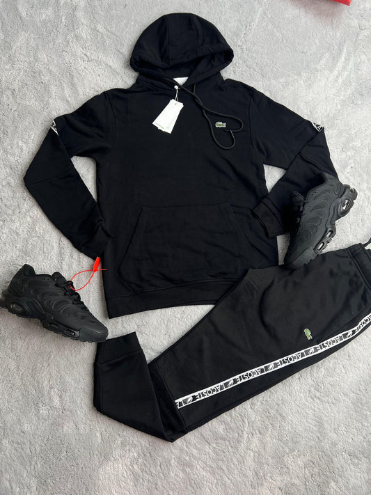 Chandal Lacoste negro tiras blancas logo verde