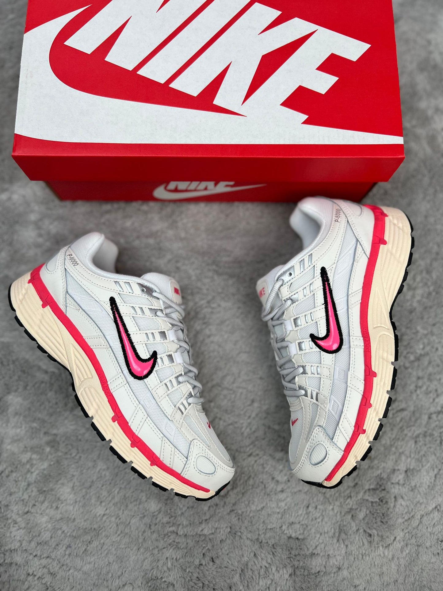 Nike P-6000 blancas logo rosa contorno negro