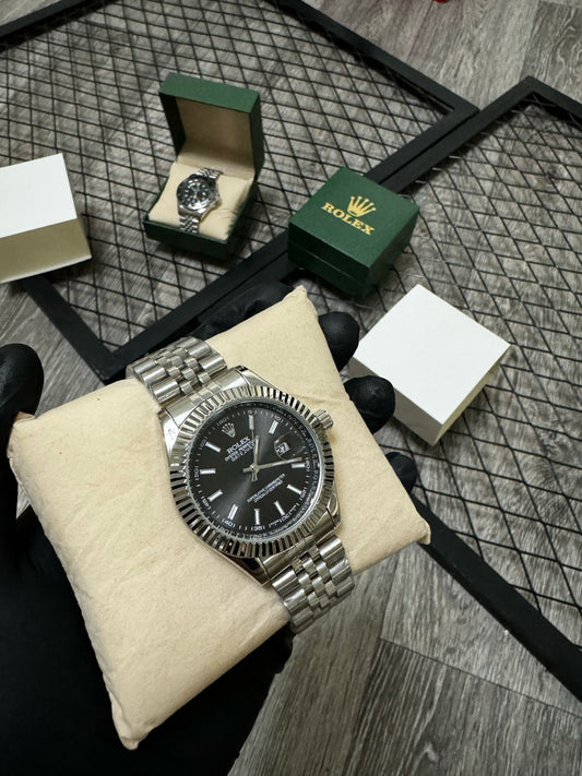 Reloj Rolex plateado y negro detalles blancos