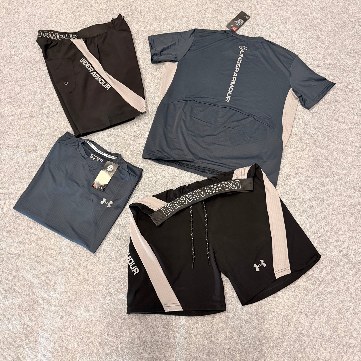 Conjunto under armour gris oscuro y negro detalles blancos
