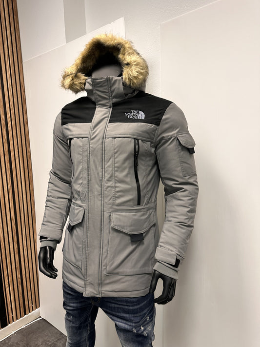 Abrigo North Face gris y negro logo blanco