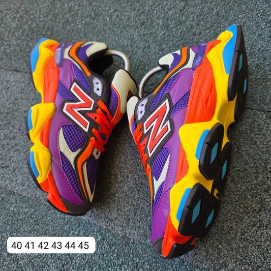 NEW BALANCE 9060 moradas logo naranja detalles amarillos y azules