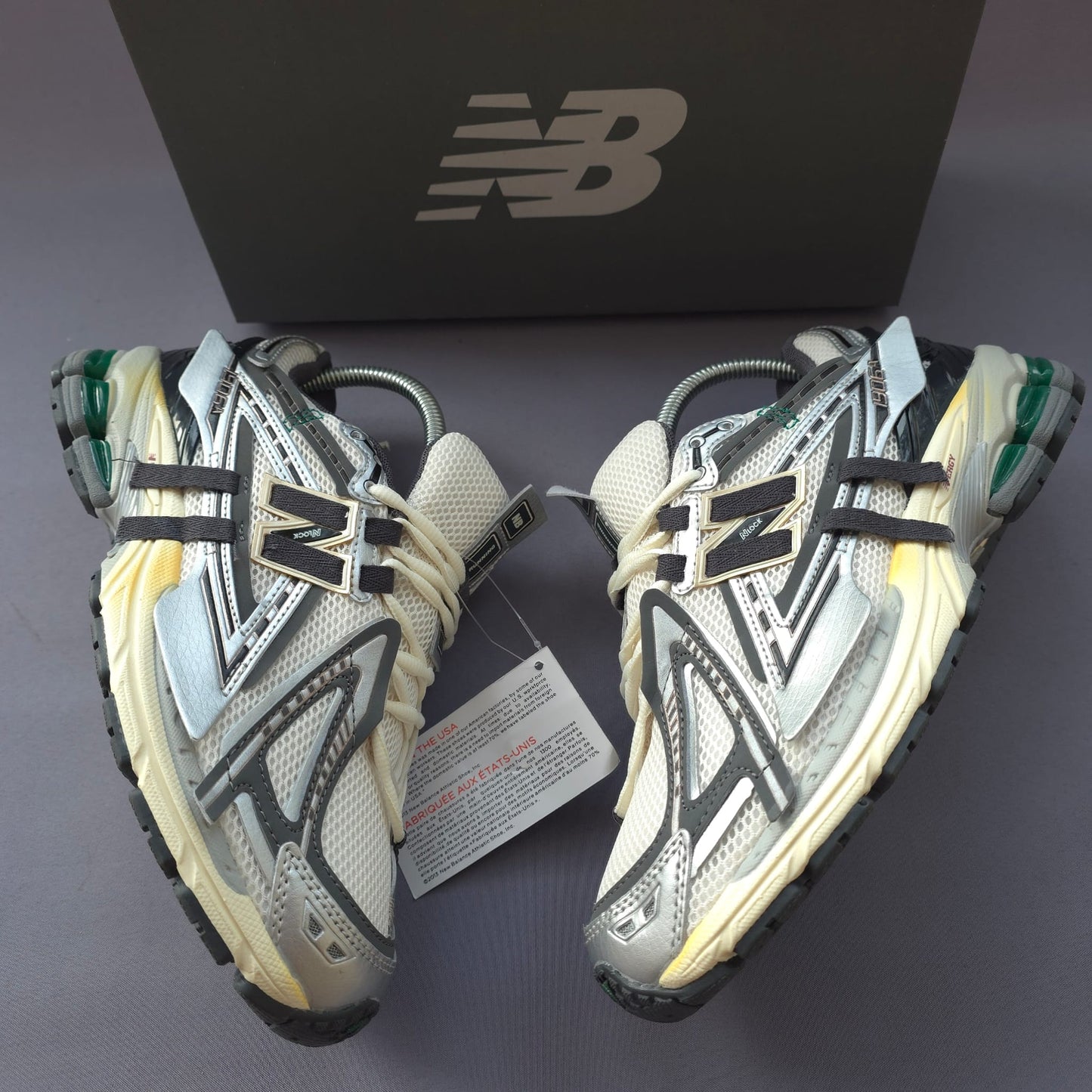 NEW BALANCE 1906R gris logo negro contorno dorado