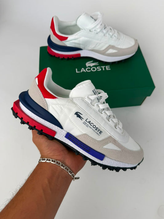 Zapatillas Lacoste Elite Active bllancas logo negro detalles azules y rojos