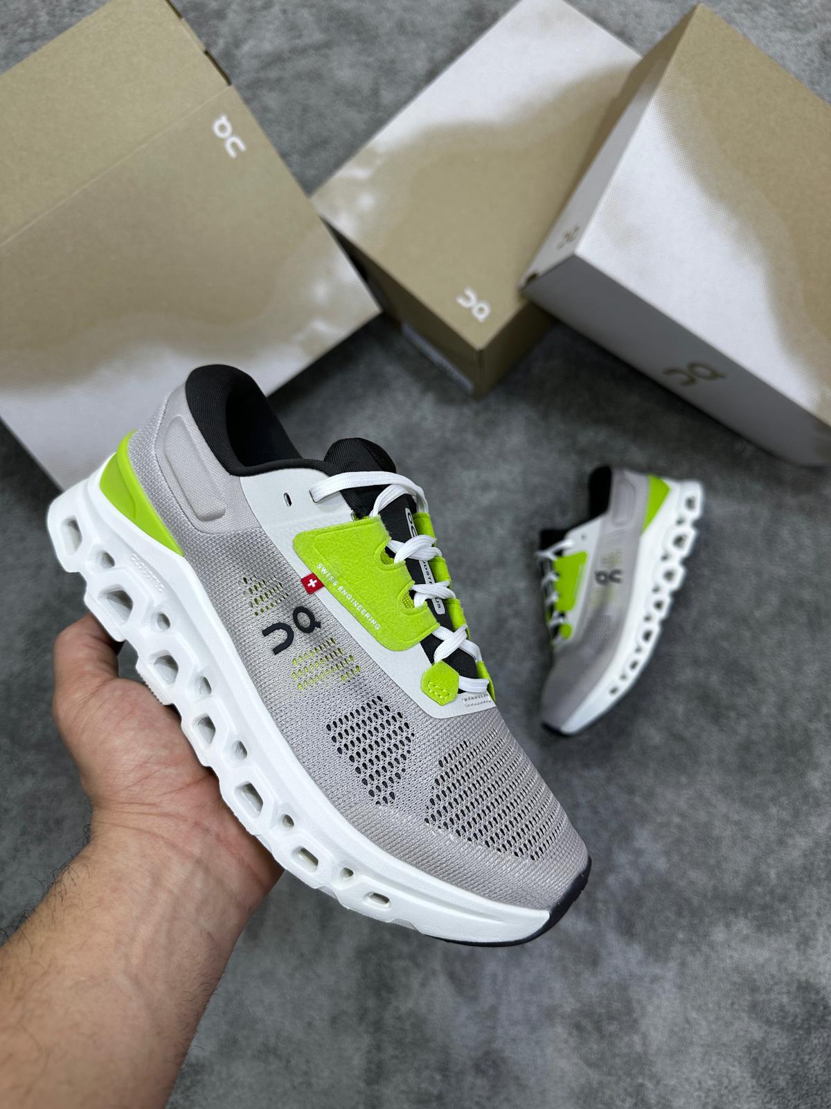 On Cloudmonster grises logo negro detalles verdes