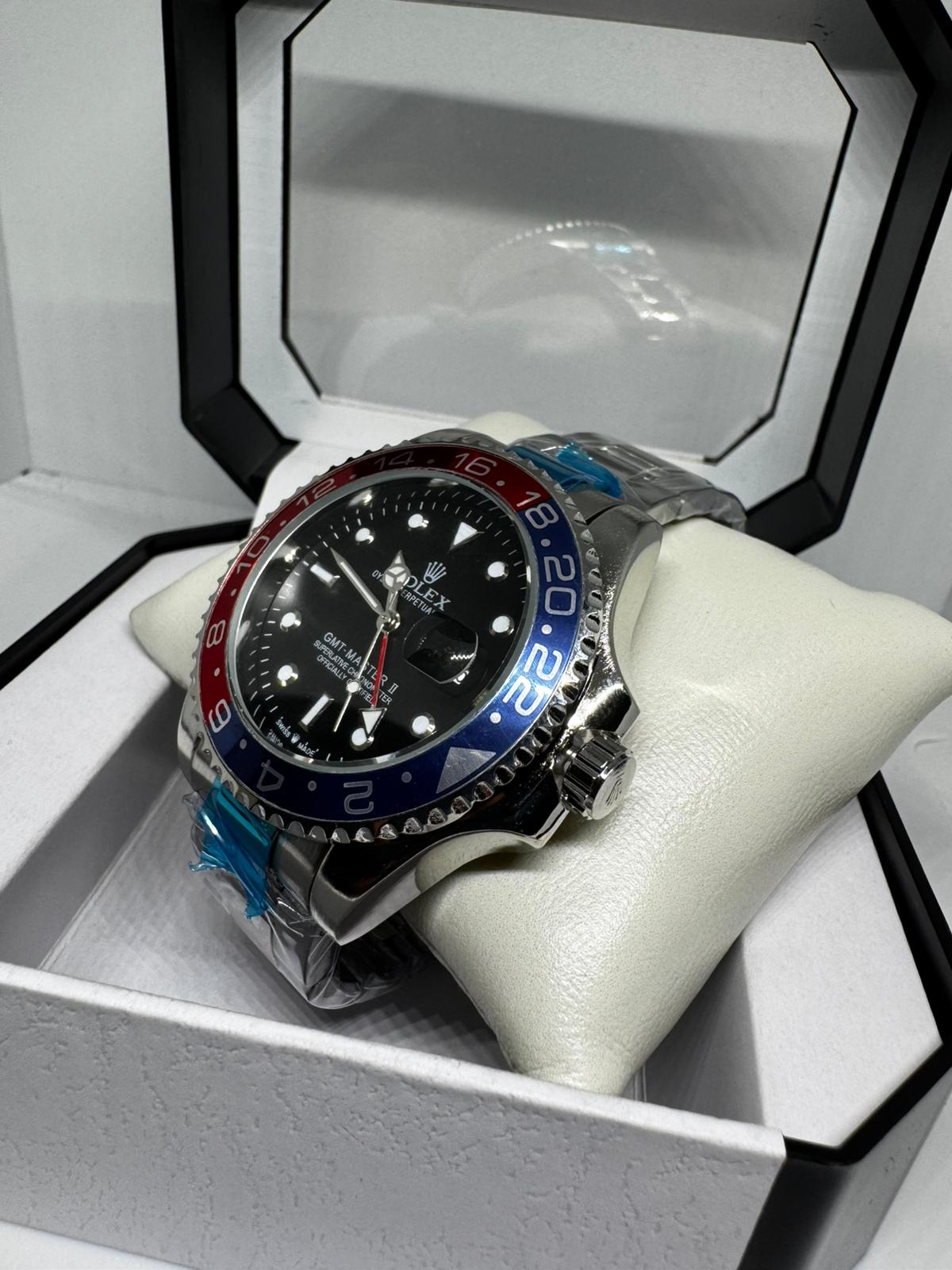 RELOJ ROLEX gris negro rojo y azul