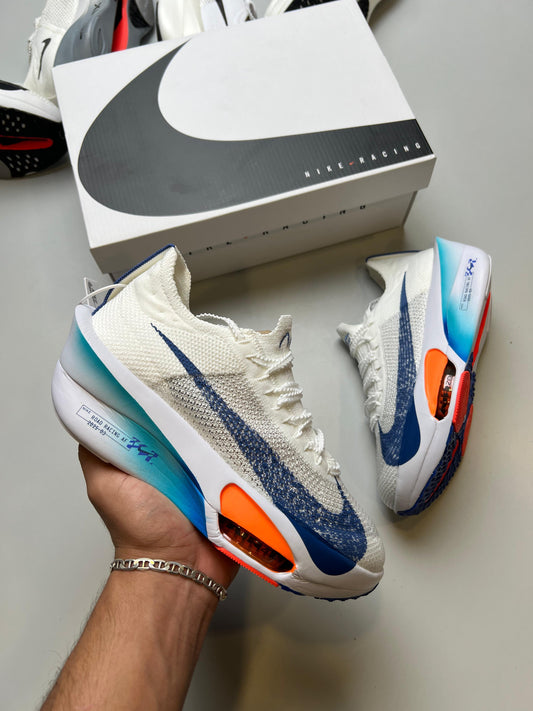 NIKE AIR ZOOM ALPHAFLY NEXT % blanco logo azul detalles naranjas