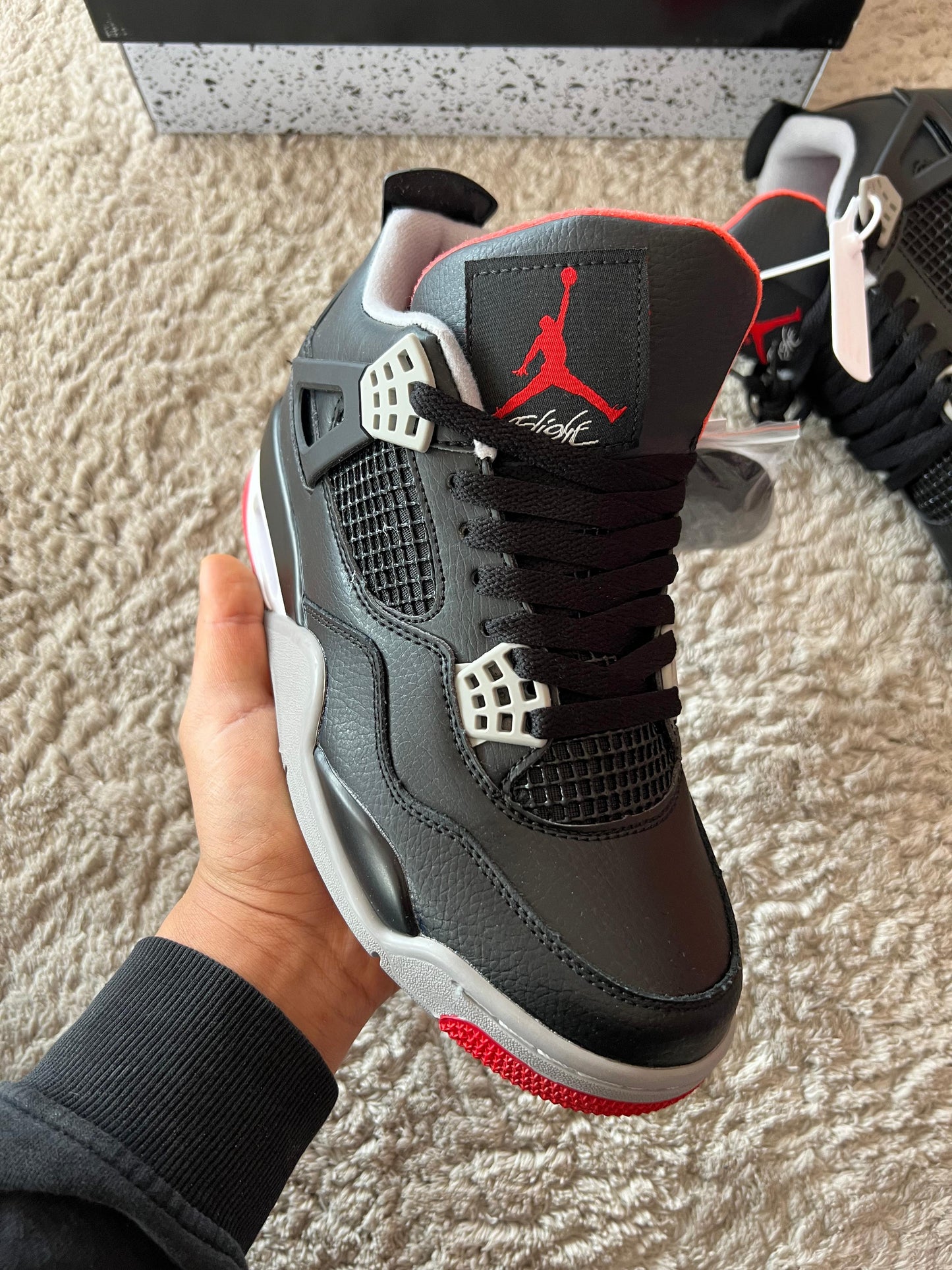 Jordan 4 negras logo rojo detalles grises
