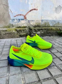 Nike ZOOMX VAPORFLY verdes logo azul detalles naranjas